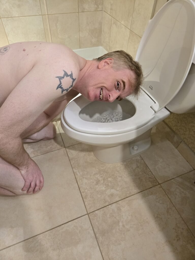 Man licking a toilet. 