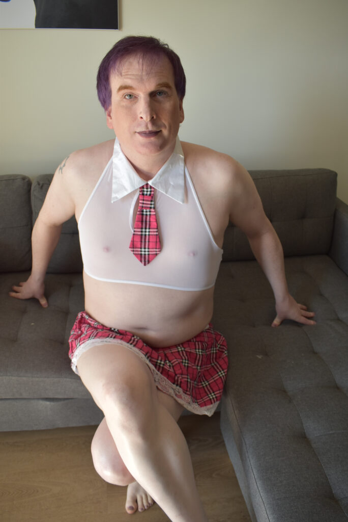 Justin Smith from Duncan, BC 2 Justin Smith from Duncan, BC dresses in cute outfit with purple lipstick and make up.